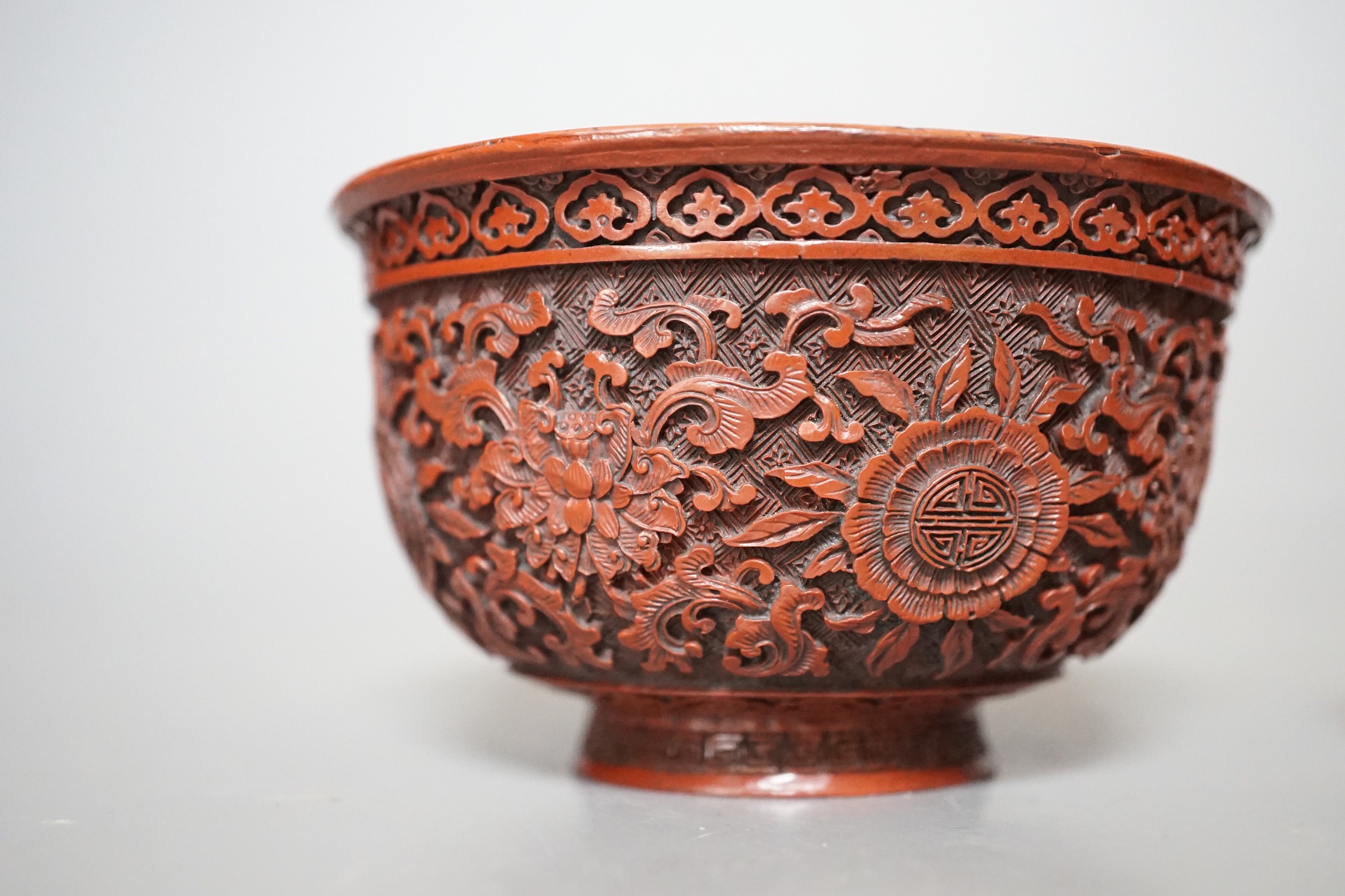 A Chinese painted metal brush rest on stand and a red lacquered bowl, 11cm
